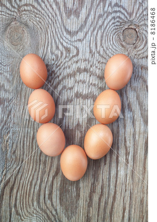 A letter v from the eggs for Easter. On a wooden texture. A letter v from the eggs for Easter. On a wooden texture. 8186468