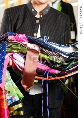 Man is buying Tracht or dirndl in a shop 8188561