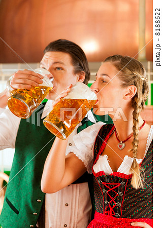 Man and woman with beer glass in brewery 8188622