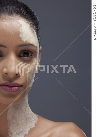 Close-up portrait of young woman with facial mask 8191761