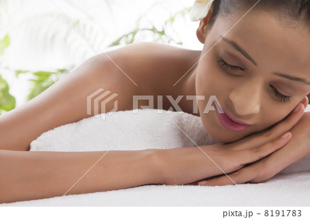 Smiling woman on massage table at spa 8191783