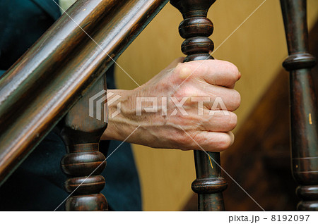 old woman wrinkled hands hold the handrail 8192097