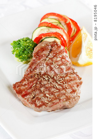 Steak with vegetables on white plate 8195046