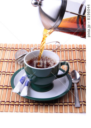 Pouring fresh  tea kettle into green cup 8196044