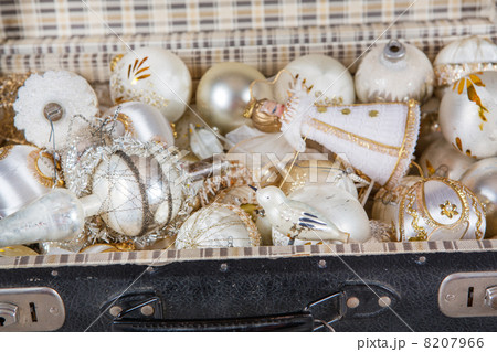 Ancient white Christmas tree toys in antique suitcase 8207966