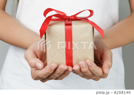 young female hands holding gift 8208140