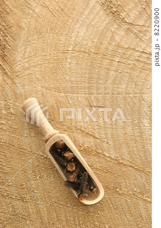 cloves in a wooden shovel on a timber board cloves in a wooden shovel on a timber board 8220900