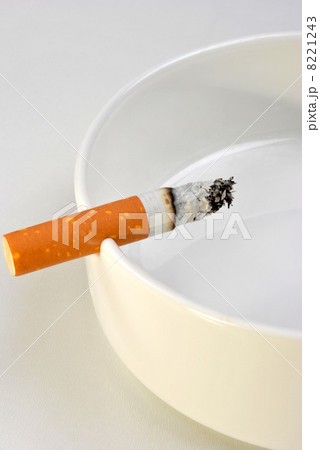 one unhealthy cigarette in a glass ashtray 8221243