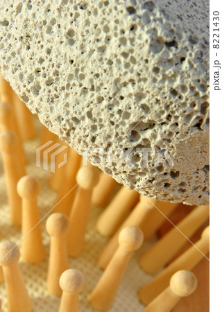 hair brush on a terry cloth towel and pumice 8221430