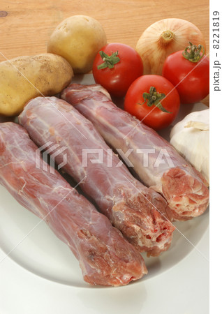 raw turkey neck with vegetables on a plate 8221819