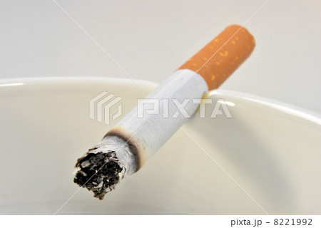 one unhealthy cigarette in a glass ashtray 8221992