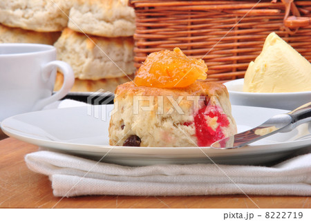 scone with organic jam on a timber board 8222719