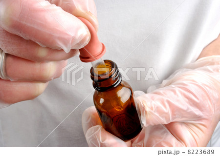 Health care staff with disposable gloves and pipette Health care staff with disposable gloves and pipette 8223689