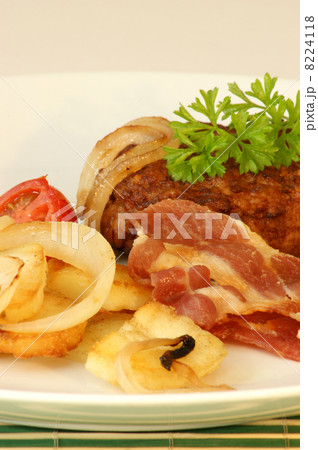 rissole with grilled bacon and onion on a plate 8224118