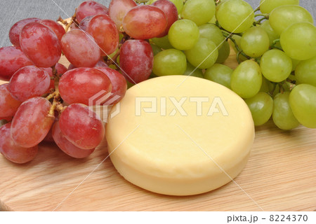 home made cheese with grapes in the background 8224370