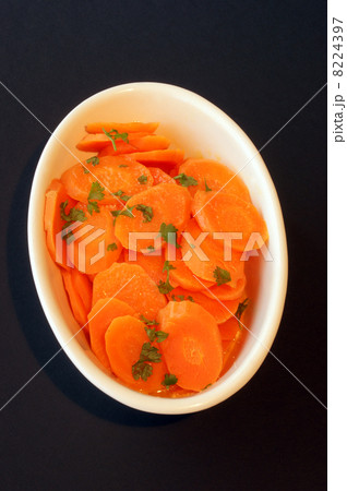 braised organic carrot and a white bowl braised organic carrot and a white bowl 8224397