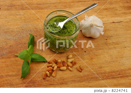 fresh pesto and garlic on a timber board 8224741