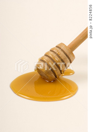 a honeyspoon and some sweet organic honey 8224856