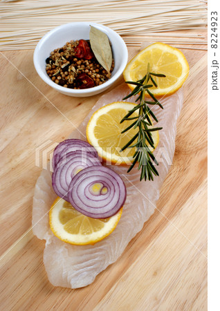 raw vietnamese river cobbler fillet on a timber board raw vietnamese river cobbler fillet on a timber board 8224923