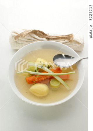 delicious vegetable soup in a white bowl with a spoon delicious vegetable soup in a white bowl with a spoon 8225217