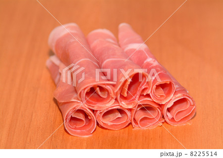 sliced ham rolled on a timber plate sliced ham rolled on a timber plate 8225514