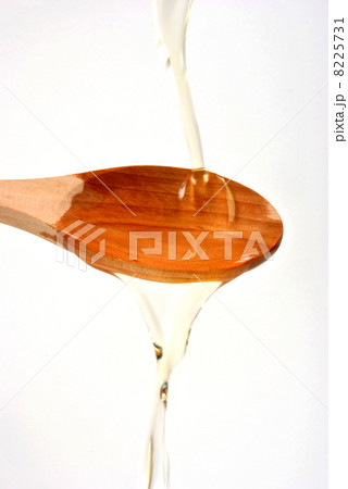 organic olive oil and a timber spoon 8225731
