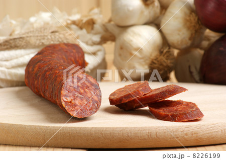 salami and some slices salami on a timber board salami and some slices salami on a timber board 8226199