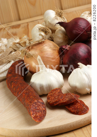 salami and some slices salami on a timber board salami and some slices salami on a timber board 8226200