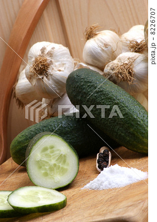 some organic gherkin, pepper and salt on a board 8226707