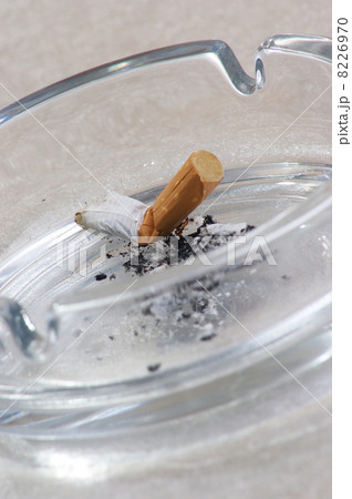 one unhealthy cigarette in a glass ashtray 8226970