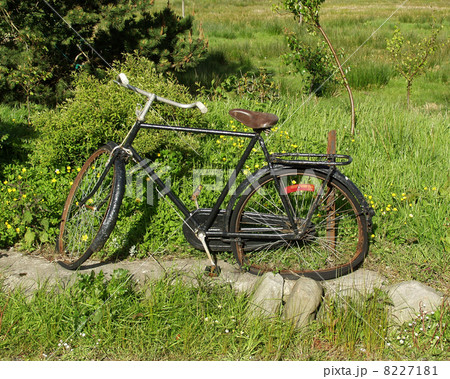 old broken black bike beside the road old broken black bike beside the road 8227181