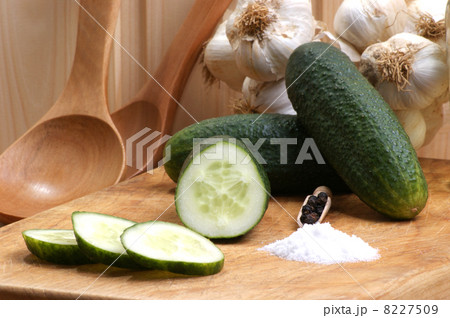 organic gherkin with salt on a timber board organic gherkin with salt on a timber board 8227509