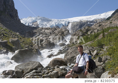 Man and a waterfall (Buarbreen glacier, Folgefonna National Park 8230375