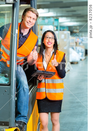 Forklift driver and supervisor at warehouse 8237056
