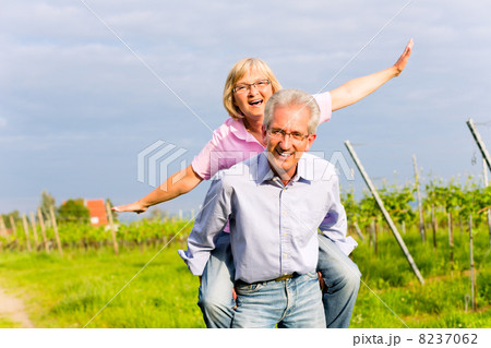 Senior man and woman walking hand in hand 8237062