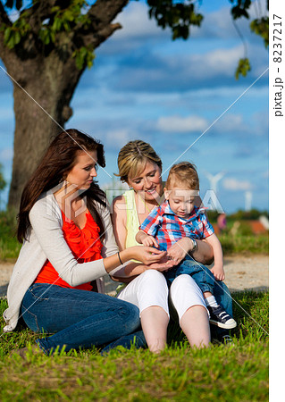 Family - Grandmother, mother and child in garden 8237217