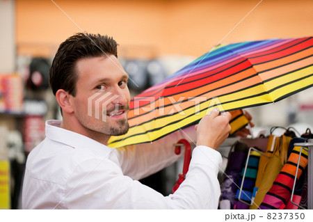 Handsome Man Shopping Umbrella at Supermarket Handsome Man Shopping Umbrella at Supermarket 8237350