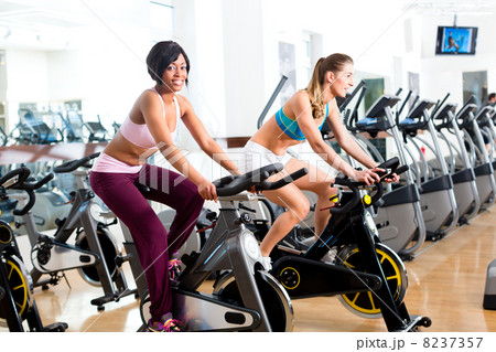 People Spinning in the gym on bicycles 8237357