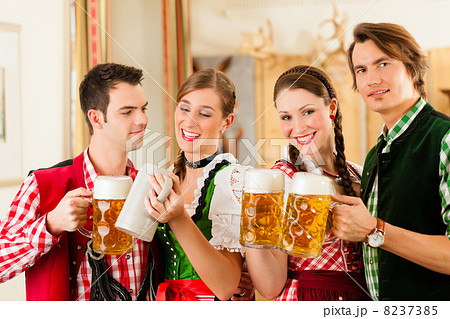 Young people in traditional Bavarian Tracht in restaurant or pub 8237385
