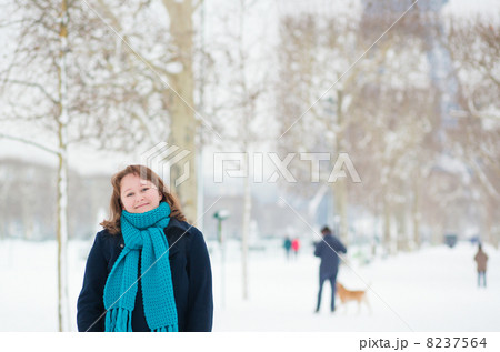 Smiling girl enjoying rare snowy day in Paris 8237564