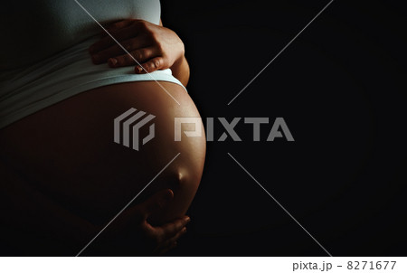 belly of pregnant woman monochrome on dark background belly of pregnant woman monochrome on dark background 8271677