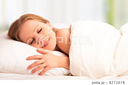 beautiful woman sleeping and smiles in his sleep in bed beautiful woman sleeping and smiles in his sleep in bed 8271678
