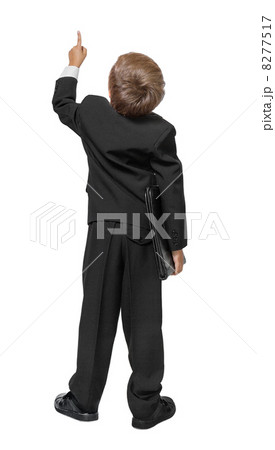 Child  in a tuxedo pointing at wall. Rear view. Isolated over wh 8277517