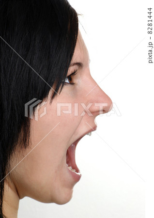 a young woman is shouting with her open mouth a young woman is shouting with her open mouth 8281444
