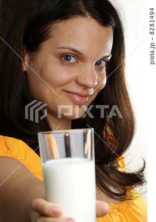 a young woman drinks organic cold milk 8281494