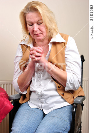 woman in a wheelchair is praying in silence 8281662