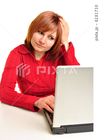 Office assistant in a red blouse working on a laptop 8281710