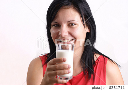 a young woman drinks organic cold milk 8281711