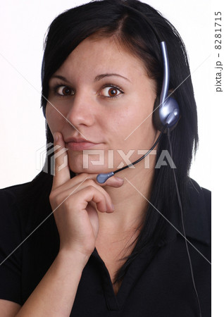 a young woman with closed mouth and headset a young woman with closed mouth and headset 8281715