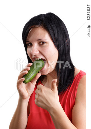 a young woman eating one organic cucumber 8281887